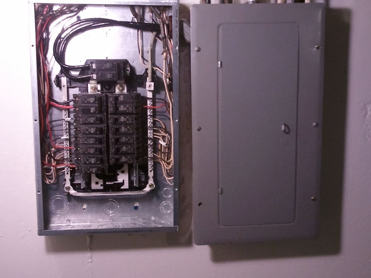 Cuadro eléctrico antiguo con la tapa retirada mostrando los circuitos y fusibles originales